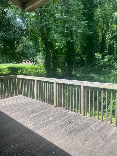 a balcony with a view of a yard and trees