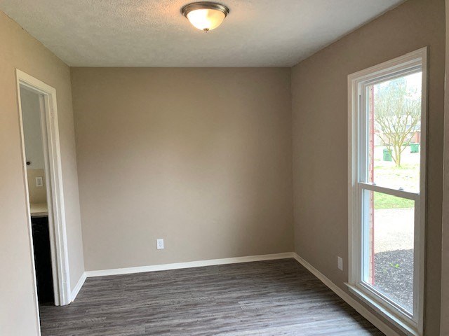an empty living room with a large window