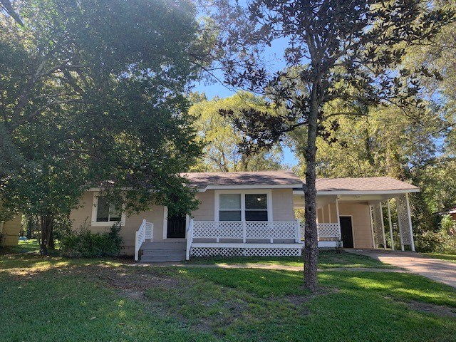 a white house with a porch and some trees