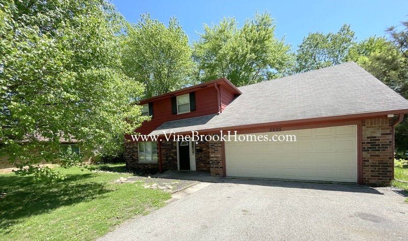 a brick house with a garage and a driveway