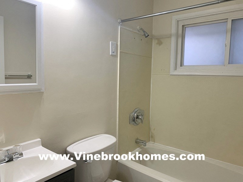 a bathroom with a toilet and a sink and a shower