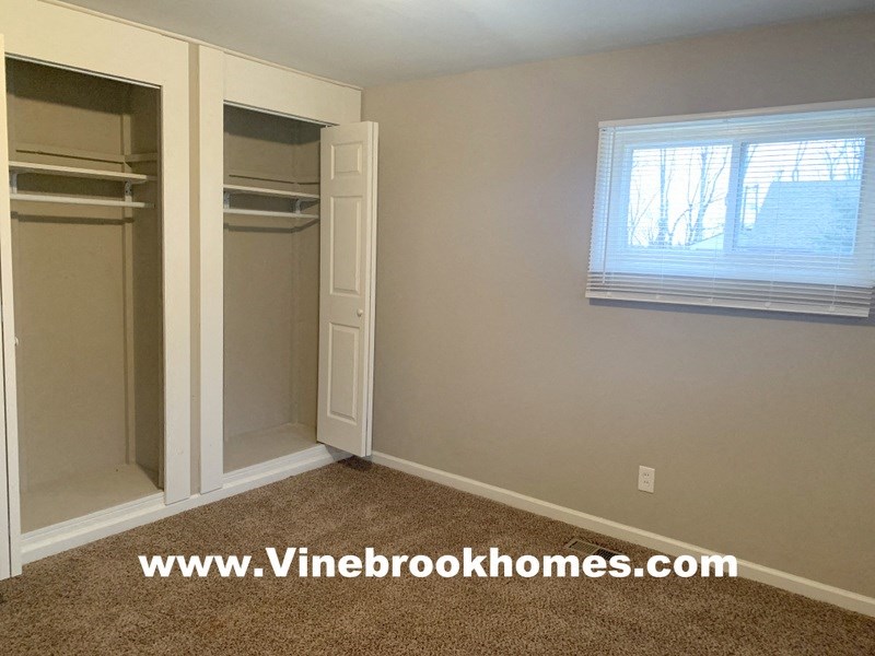 a bedroom with a closet and a window