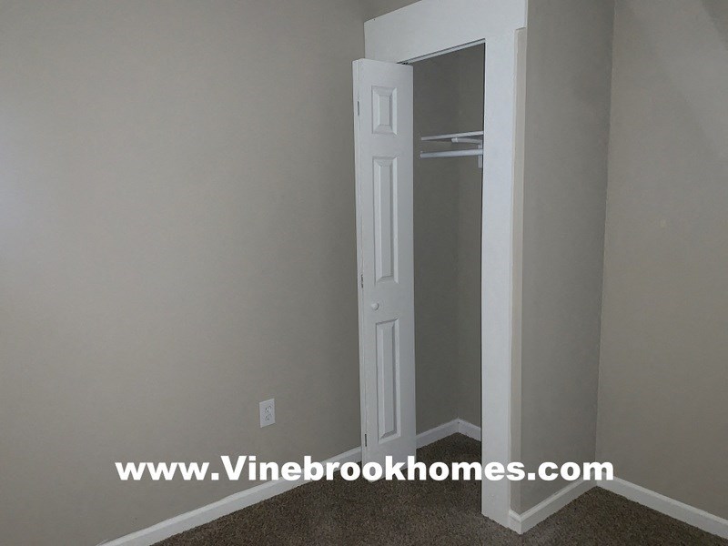 a closet in a small room with a white door