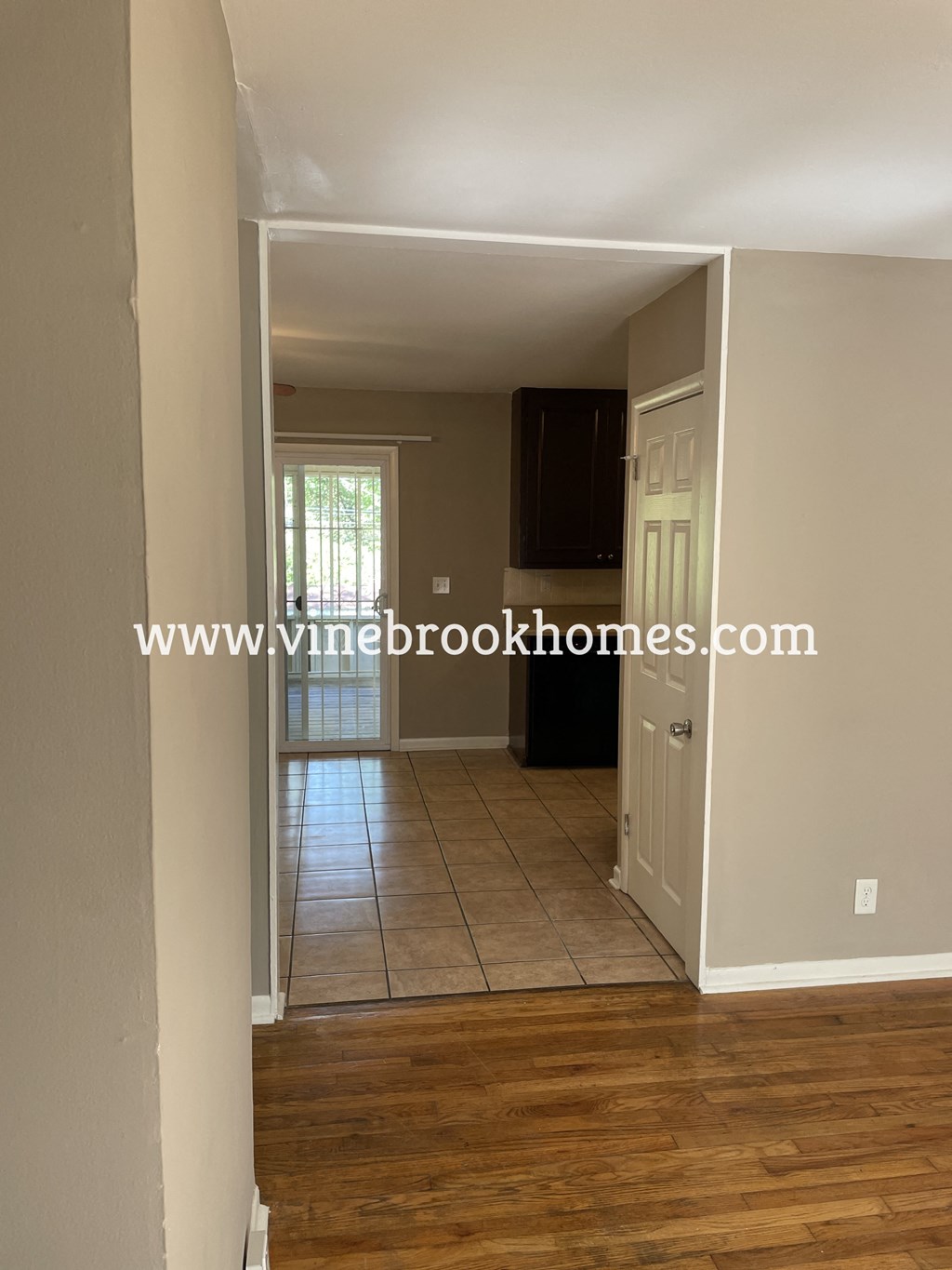 a view of the living room from the dining room looking into the kitchen