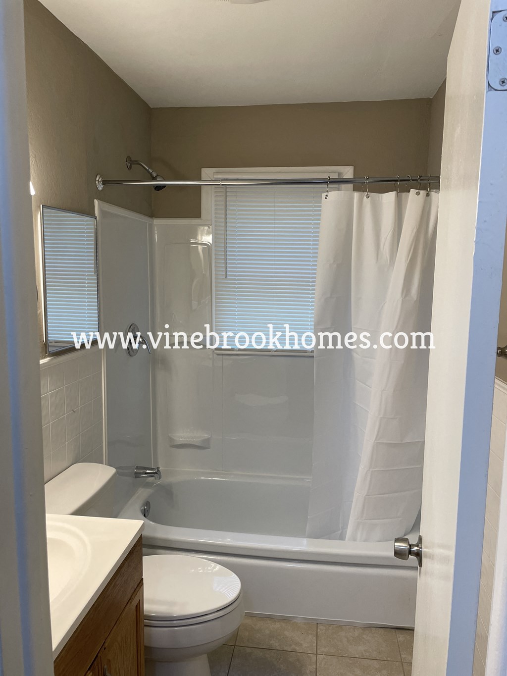 a small bathroom with a shower toilet and sink