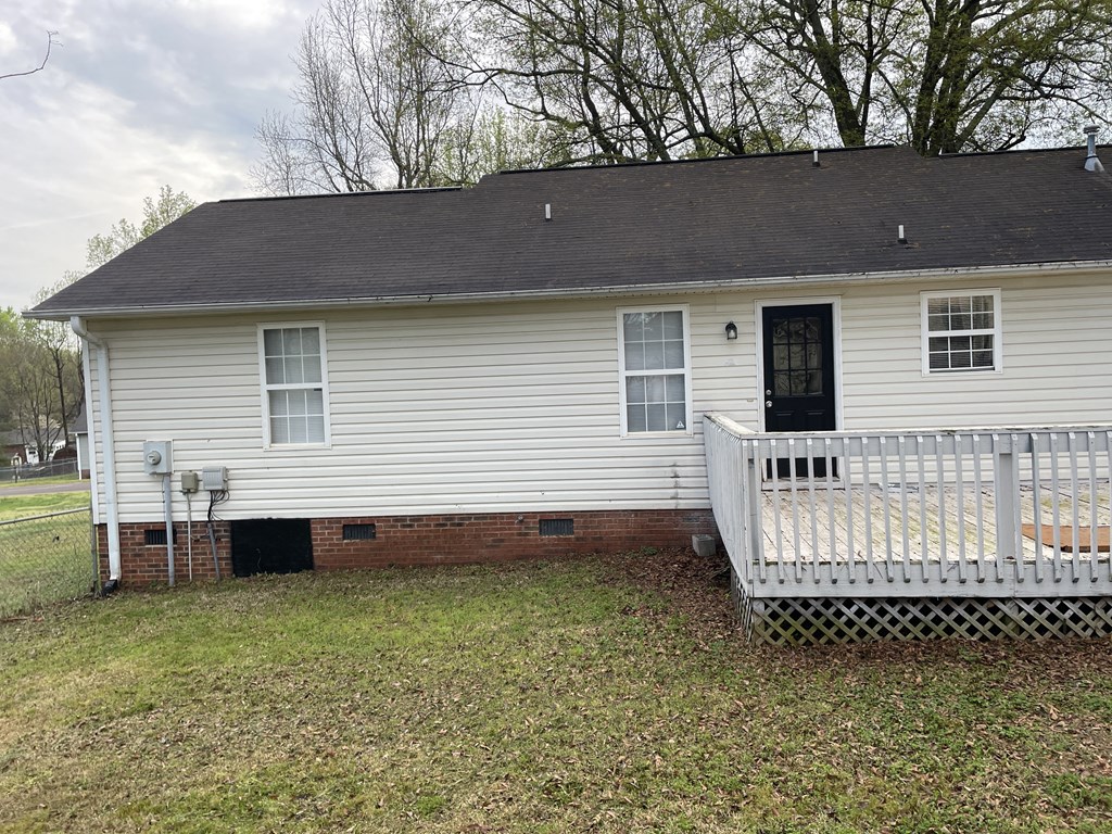 a white house with a white deck and a white fence
