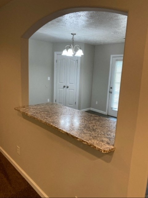 a kitchen with a granite counter top and a mirror