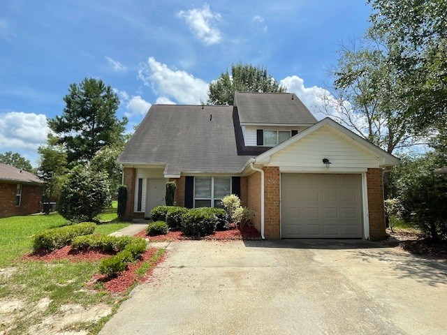 A two-story house with a garage and a driveway.