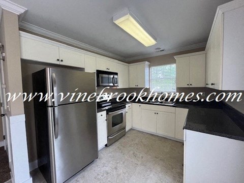 a kitchen with a stainless steel refrigerator and a microwave