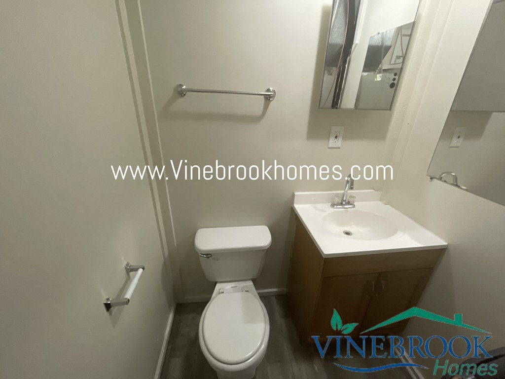 a bathroom with a toilet and a sink and a mirror