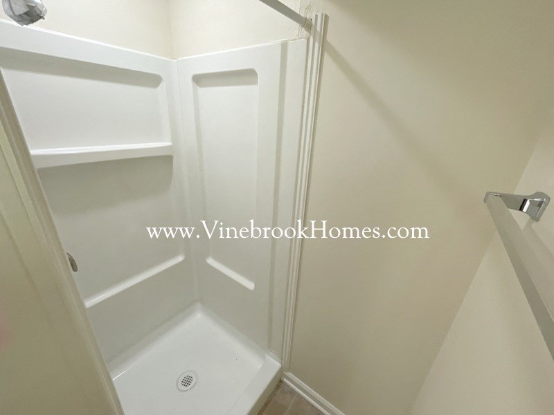 a small bathroom with a shower and a sink