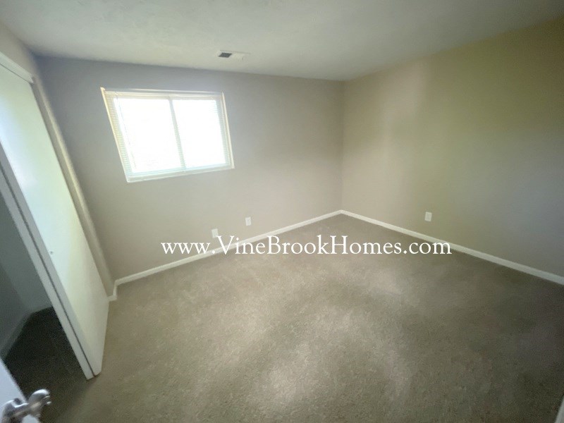 a small room with a white wall and a window