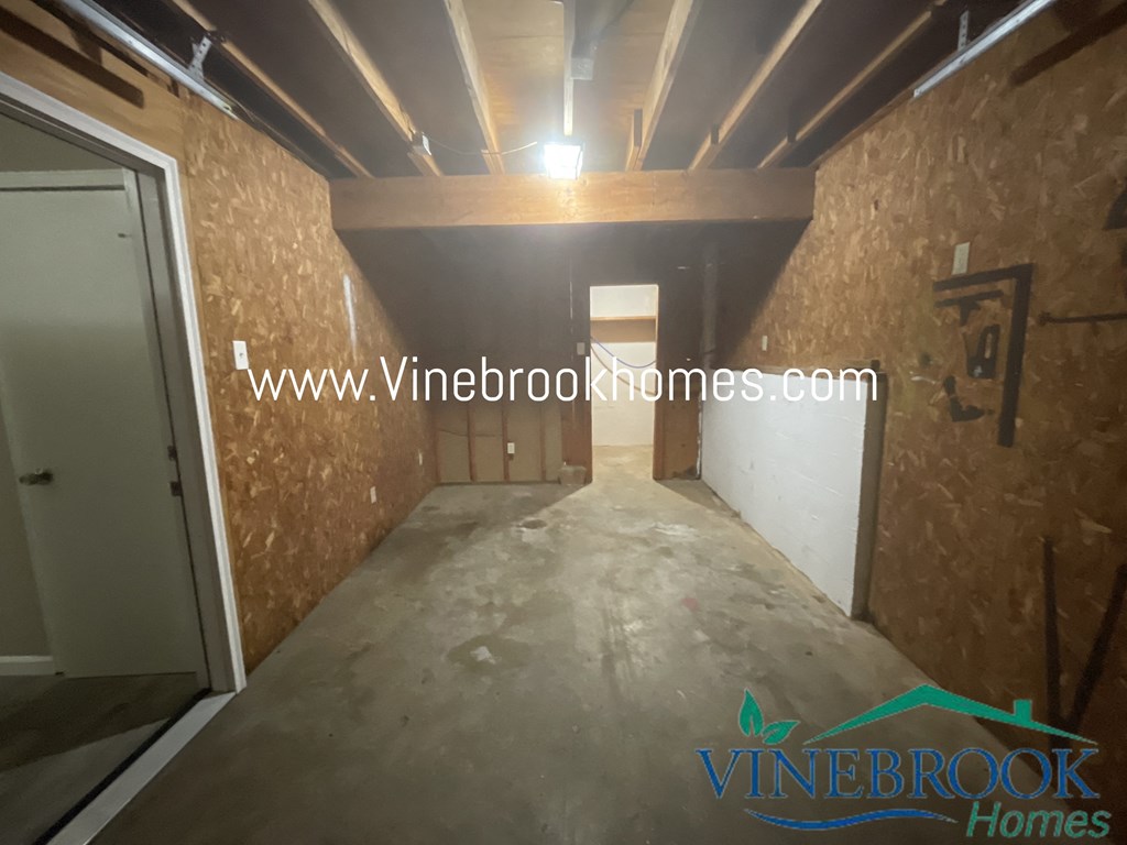 a large room with a concrete floor and a door