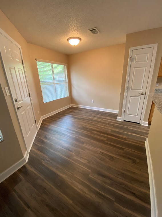 A room with wooden floors and white doors.