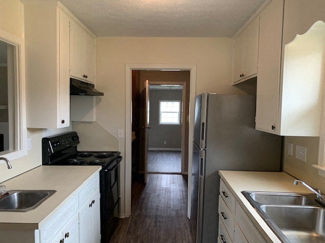 a kitchen with stainless steel appliances and white cabinets