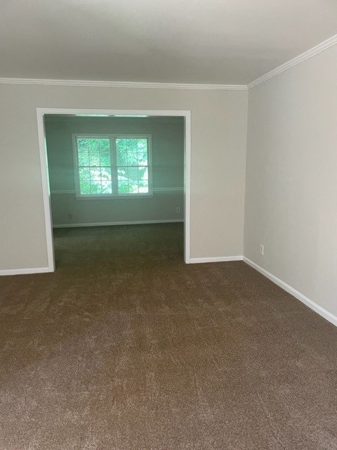 an empty living room with a window in it