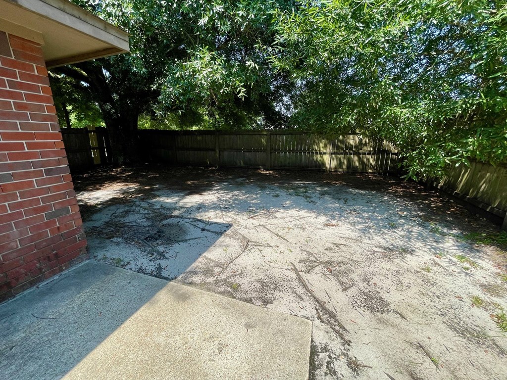 the back yard of a house with a pool and trees