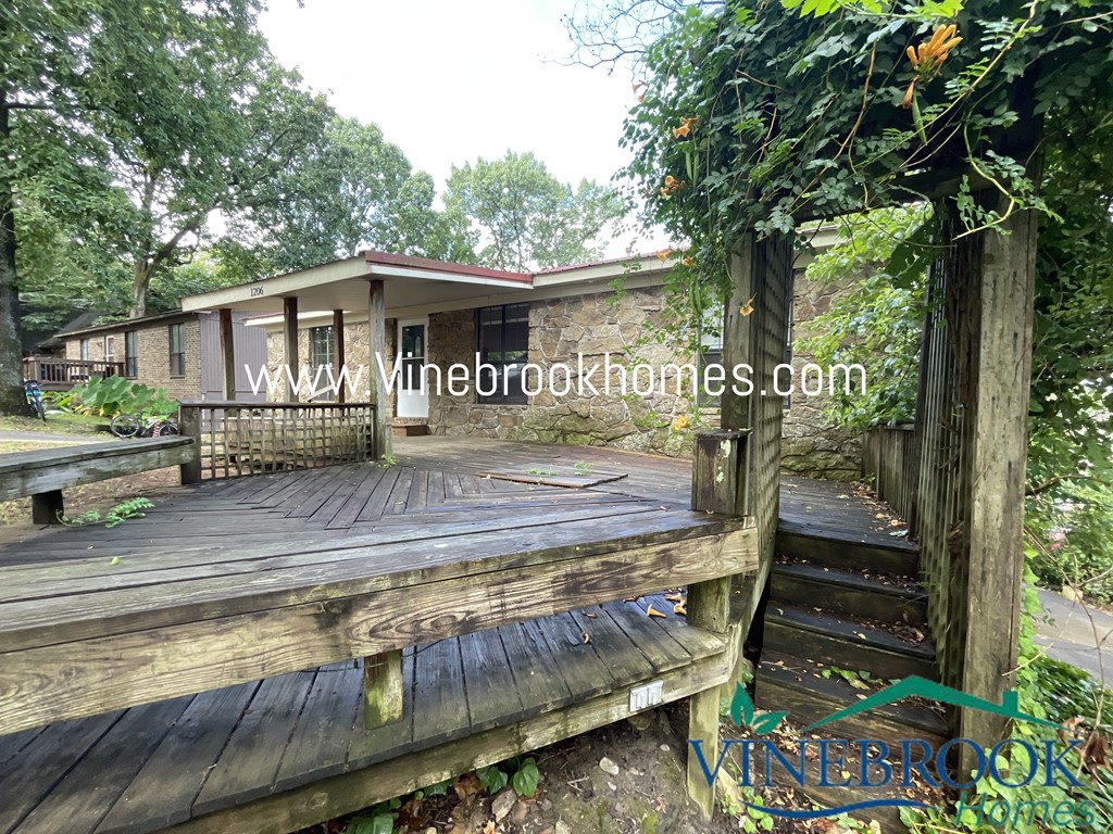 a house with a wooden deck in front of it