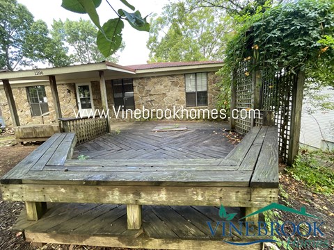 a large wooden deck in front of a house