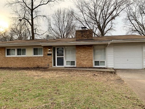 a brick house with a white garage door