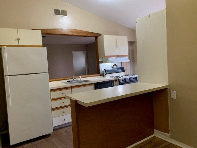 a kitchen with a stove and a refrigerator