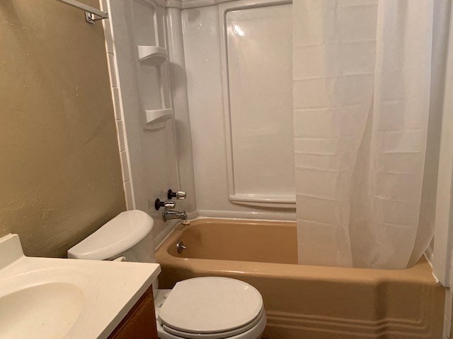 a bathroom with a toilet and a tub and a sink