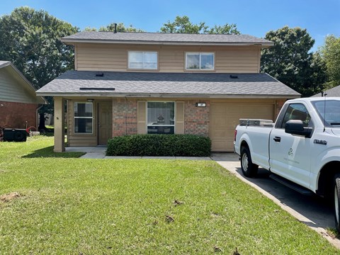 a house with a truck parked in front of it