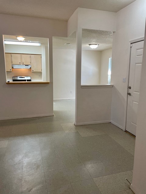 an empty living room and kitchen in an empty house