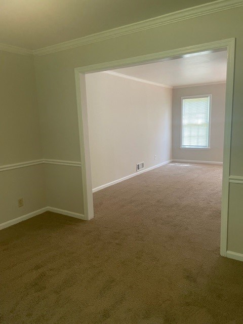 an empty room with a window and a carpet