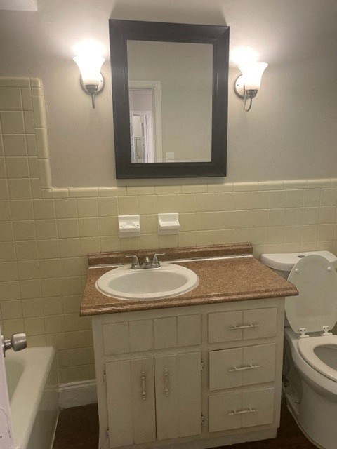 a bathroom with a sink and a toilet and a mirror