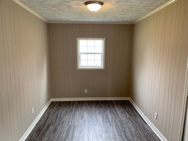an empty room with wood floors and a window