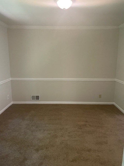 an empty room with a carpeted floor and white walls