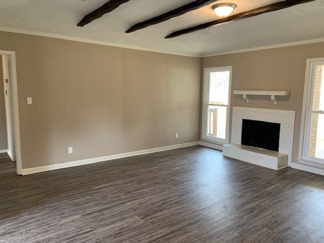 a living room with a fireplace and wooden floors