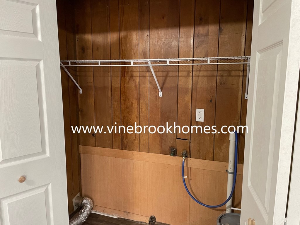 a walk in shower in a bathroom with wooden walls