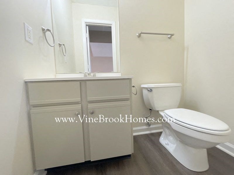 a bathroom with a toilet and a sink and a mirror