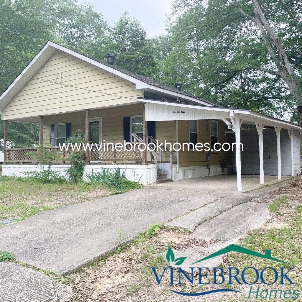 a house with a covered porch and a driveway