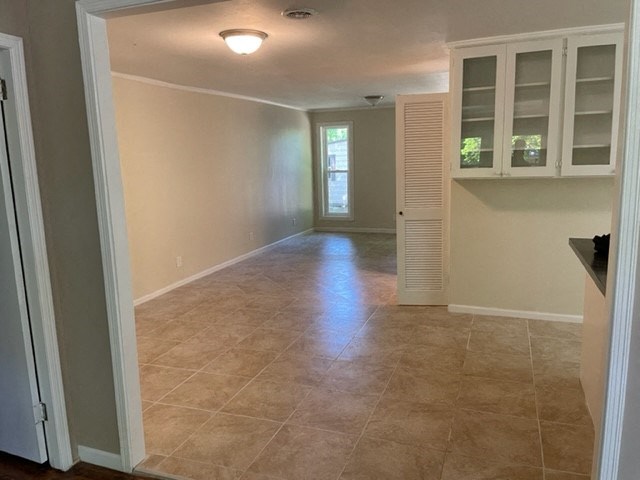 a empty room with a kitchen and a door