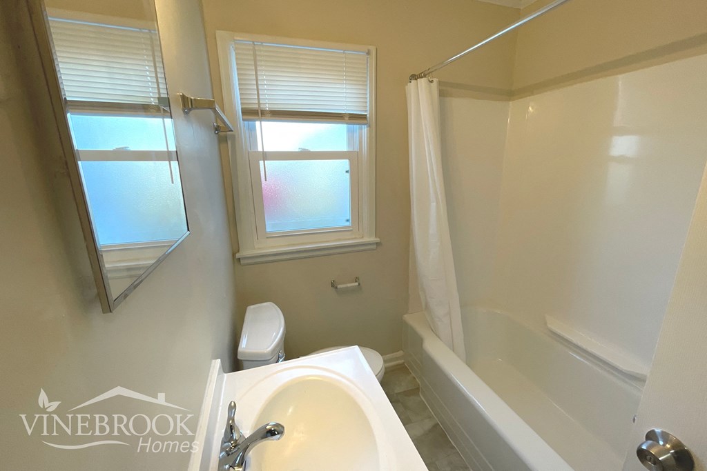 a bathroom with a sink toilet and a bath tub