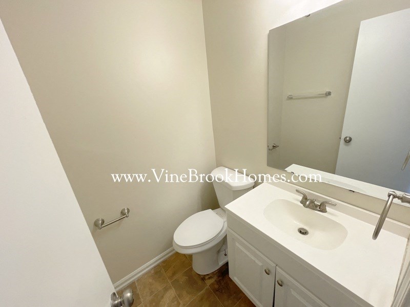 a bathroom with a sink toilet and a mirror