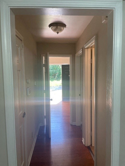 a hallway with doors and a light on the ceiling