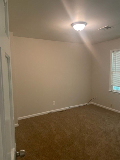 an empty room with a light on the ceiling