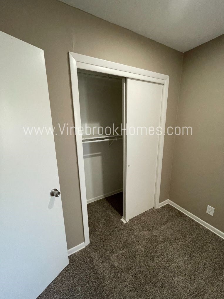 a closet in a small room with a open door