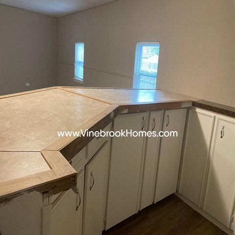 A kitchen under construction with a countertop and cabinets.