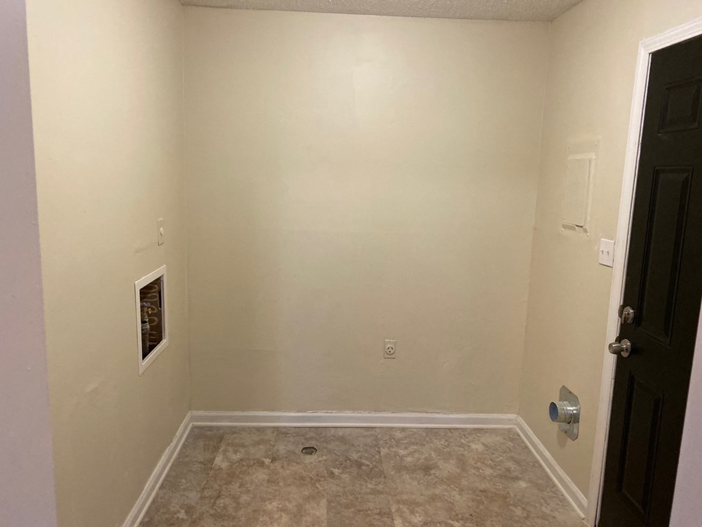 a empty room with a wall and a door