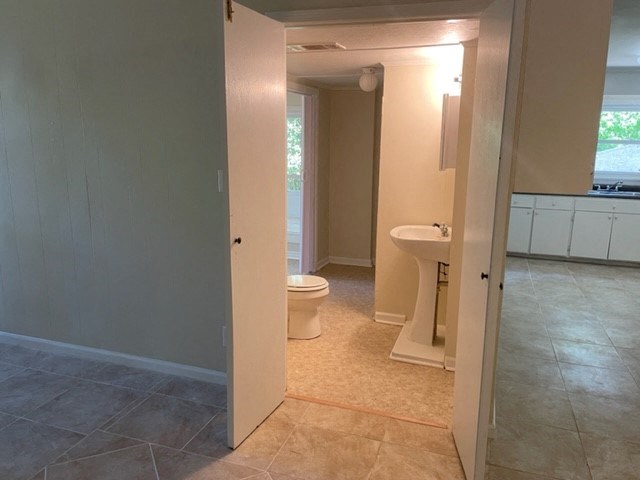 an empty bathroom with a toilet and a sink