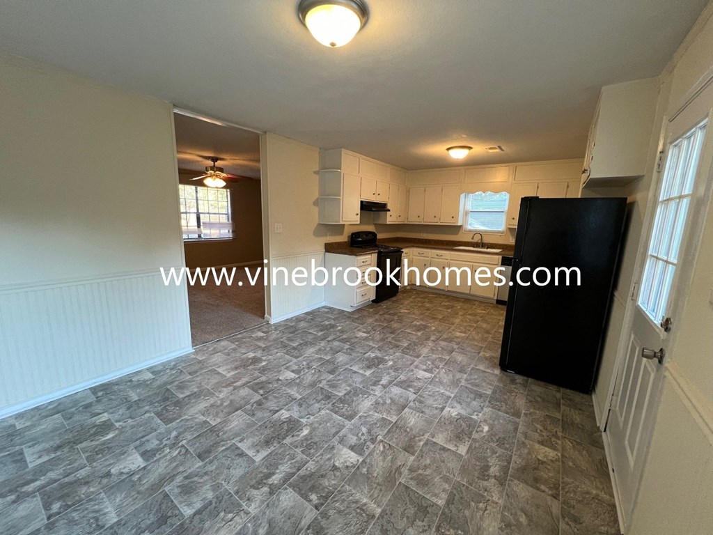 a view of the living room and kitchen from the dining room