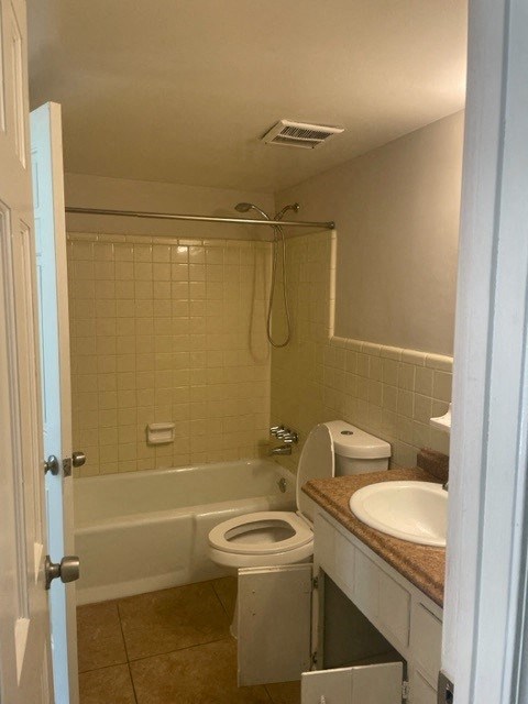 a bathroom with a toilet and a sink and a bath tub