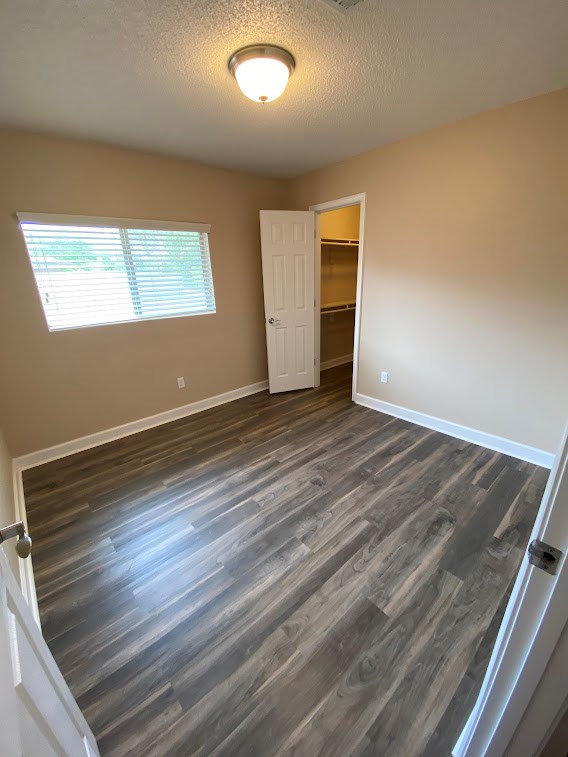 A room with a wooden floor and a white door.