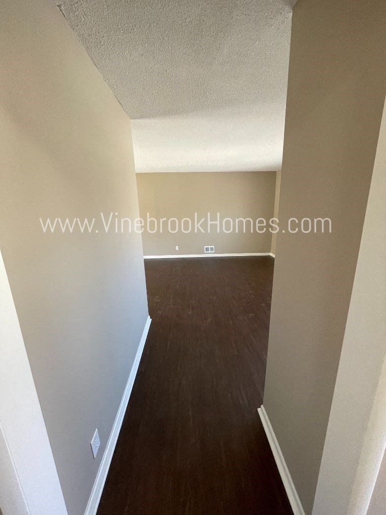 a view of the living room and hallway from the third floor