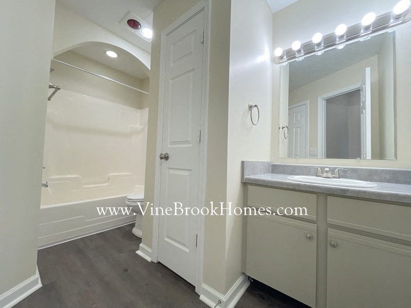 a bathroom with a large mirror and a sink and a shower
